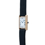 The Cartier Tank Louis is a gold rectangular wristwatch featuring a black leather strap and Roman numerals on its white dial.