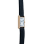 A Cartier Tank Louis wristwatch with a black leather strap and a white Roman numeral dial, shown from the side.