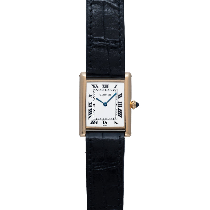 The Cartier Tank Louis watch features a square face with Roman numerals and a black leather strap.