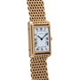 Cartier Tank Louis watch featuring a rectangular face, Roman numerals, and a gold mesh bracelet, shown at an angle.