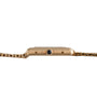 Side view of the Cartier Tank Louis gold wristwatch featuring a linked band and a round black crown.