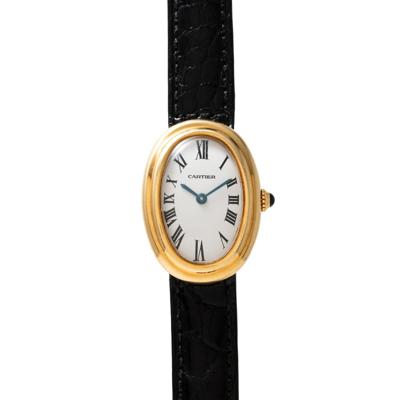 Cartier Baignoire wristwatch featuring a white oval face with Roman numerals and a black leather strap.