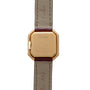 Back of a square gold Cartier Ceinture Diamond watch with brown leather strap and engraved Cartier branding.