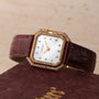 The Cartier Ceinture Diamond watch features a diamond-studded design with a maroon leather strap, displayed on a matching Cartier box.