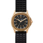 A Patek Philippe Aquanaut wristwatch in gold with a black dial, black textured rubber strap, and date display.