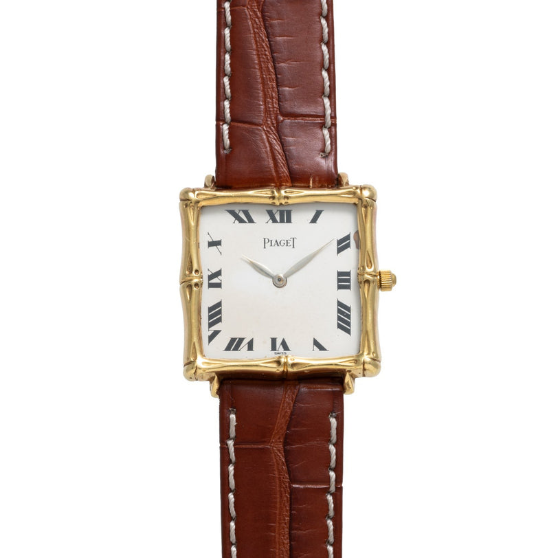Bamboo Dress Watch by Piaget: gold square case, Roman numerals, and brown leather strap shown on a white background.
