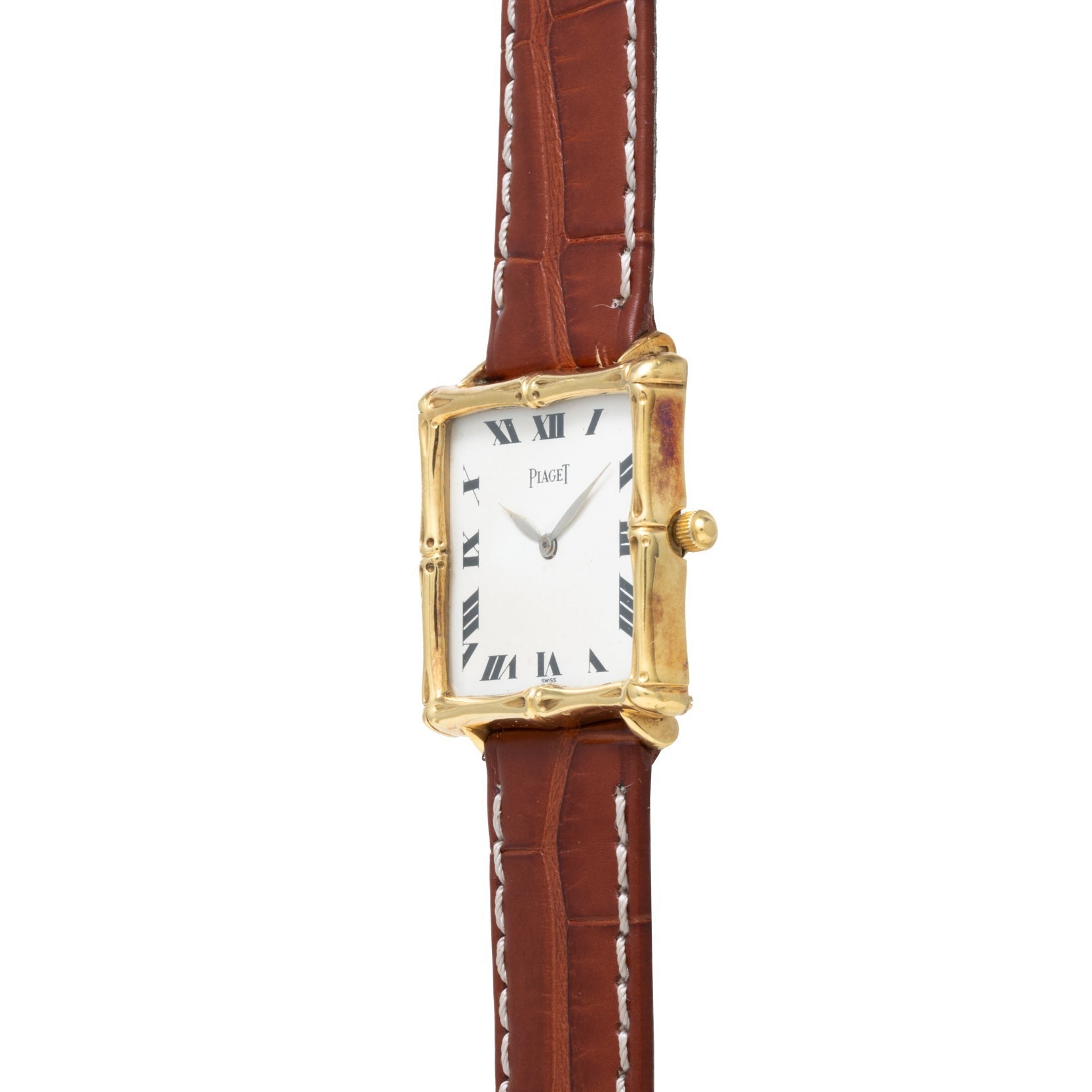 The Piaget Bamboo Dress Watch features a gold square case, white dial with Roman numerals, and a brown leather strap with white stitching.