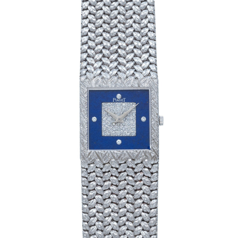 The Piaget Tradition Lapis Lazuli Diamond Dress Watch features a textured silver band, diamond-studded face, and a striking blue square bezel.
