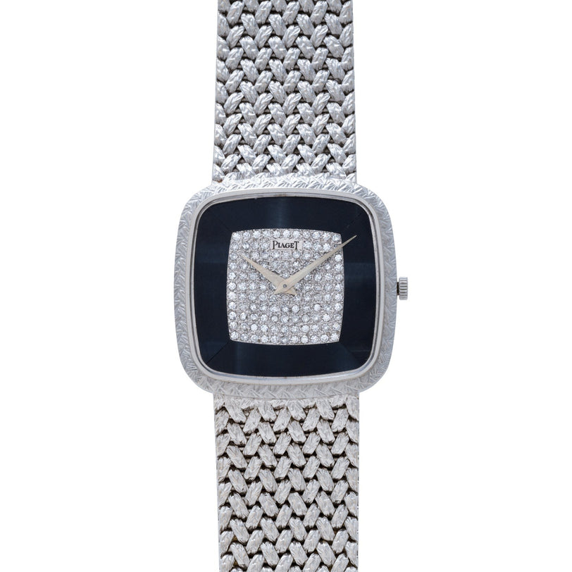 The Piaget Hawk Eye White Gold Dress Watch features a luxurious textured band and a diamond-studded square face.