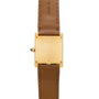 Back view of the Cartier Tank Louis watch featuring a gold case, brown leather strap, and inscribed with Cartier Paris.