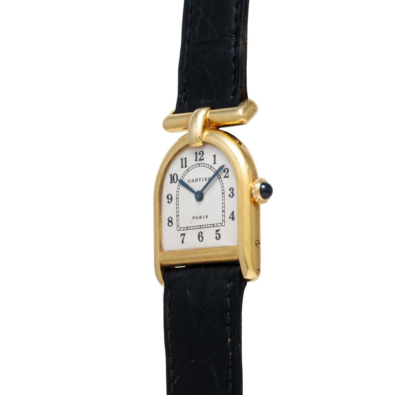 Cartier Calandre gold wristwatch featuring a unique arch-shaped face and black leather strap, displaying the time as 12:00.