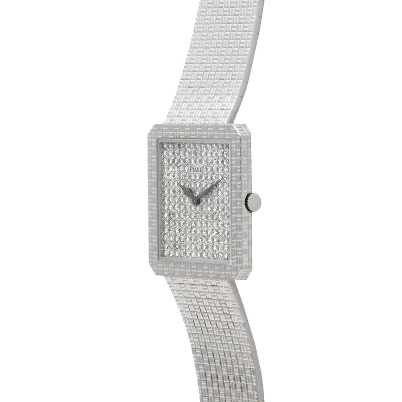 The Piaget Brick Diamond Dress Watch features a square face, silver finish, textured band, and a diamond-encrusted dial.