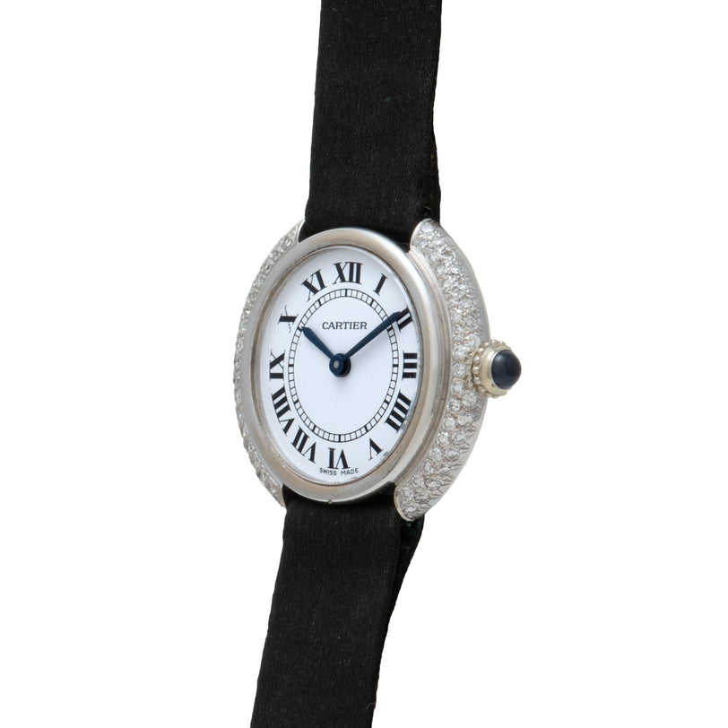 The Cartier Vendome Diamond wristwatch features a black strap, Roman numerals, and a diamond-studded silver bezel.