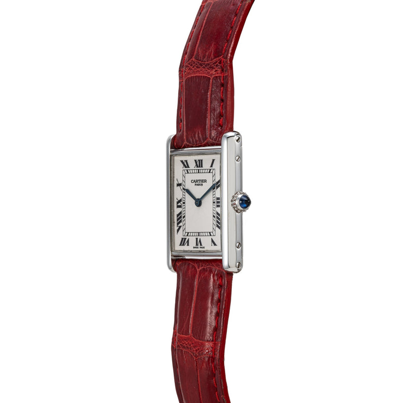 The Cartier Tank Louis features a silver rectangular case, Roman numerals, and a red leather strap, shown in a side view.