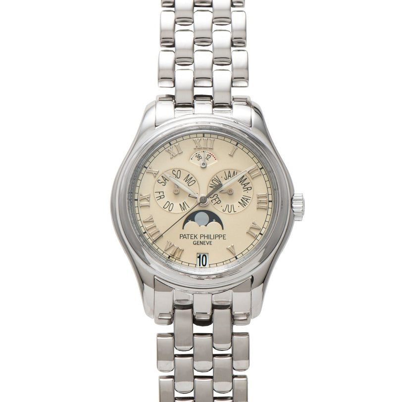 A silver Patek Philippe Annual Calendar wristwatch featuring a beige dial with multiple calendar displays.