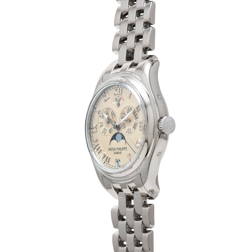 Patek Philippe Annual Calendar wristwatch with metal link band and cream dial, displayed at an angle.