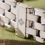 Close-up of a silver metal watch bracelet from the Patek Philippe Annual Calendar, featuring the brands logo engraved on the clasp.