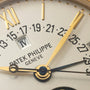 Close-up of the Patek Philippe Retrograde Perpetual Calendar watch face, featuring gold hands, date numbers, and a highlighted IV window.