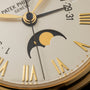 Close-up of the Patek Philippe Retrograde Perpetual Calendar watch face, featuring Roman numerals and a moon phase indicator.