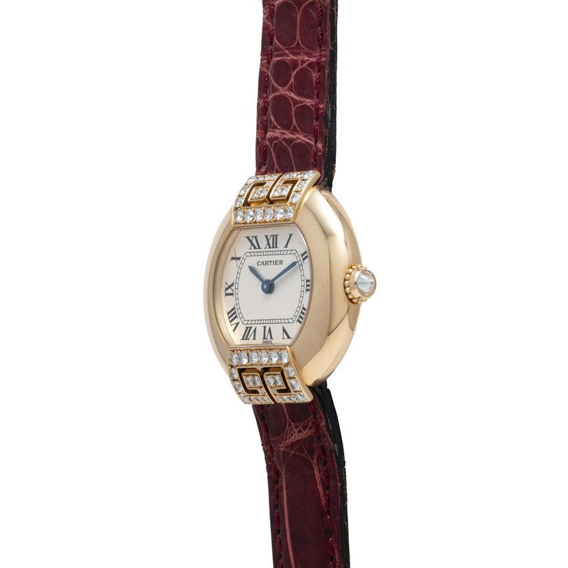 Cartier Ellipse watch featuring diamond accents and a burgundy leather strap, displayed in a side view.