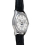 The Patek Philippe Annual Calendar Moonphase features multiple dials on a white face and a black leather strap, displayed at an angle.