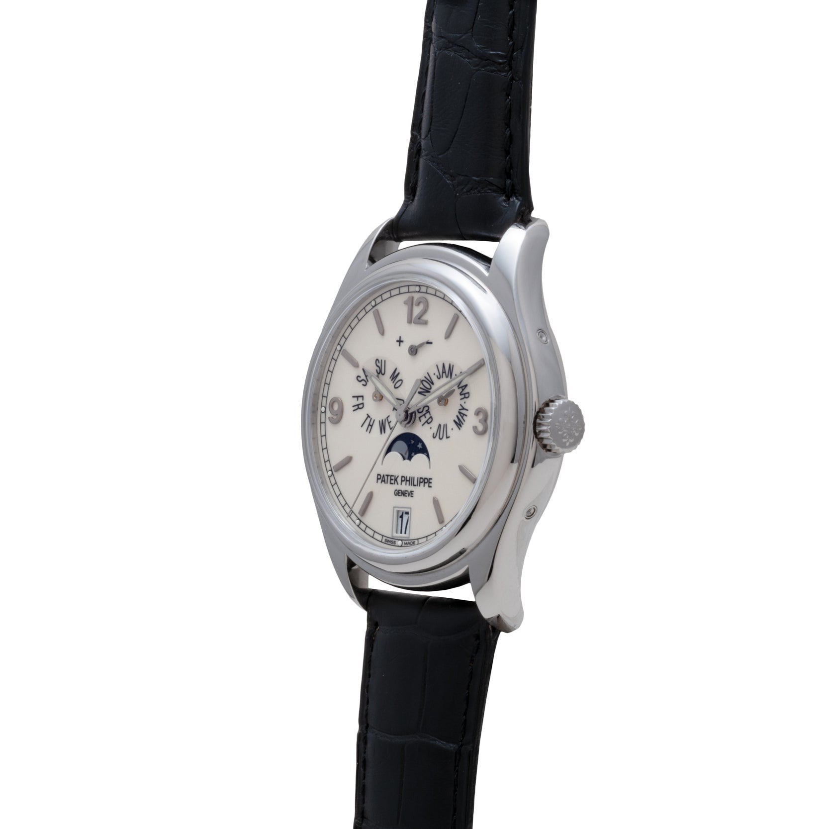 The Patek Philippe Annual Calendar Moonphase wristwatch features a silver case, black leather strap, and moon phase display, shown at an angle on a white background.