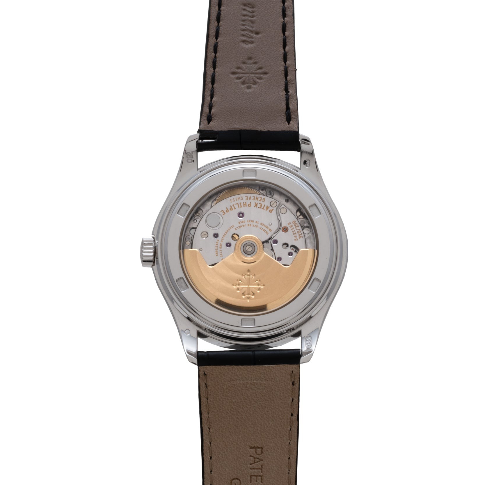 A close-up of the Patek Philippe Annual Calendar Moonphase watch’s exposed mechanical movement and rotor, visible through its transparent case back.