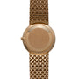 Patek Philippe Calatrava gold wristwatch featuring a round, plain back case and a textured metal bracelet, shown from the back.