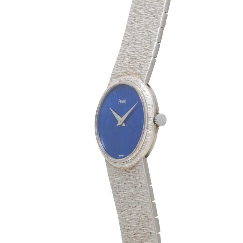 Piaget White Gold Lapis Lazuli Dress Watch featuring a textured band and a round blue face, shown from a side angle.