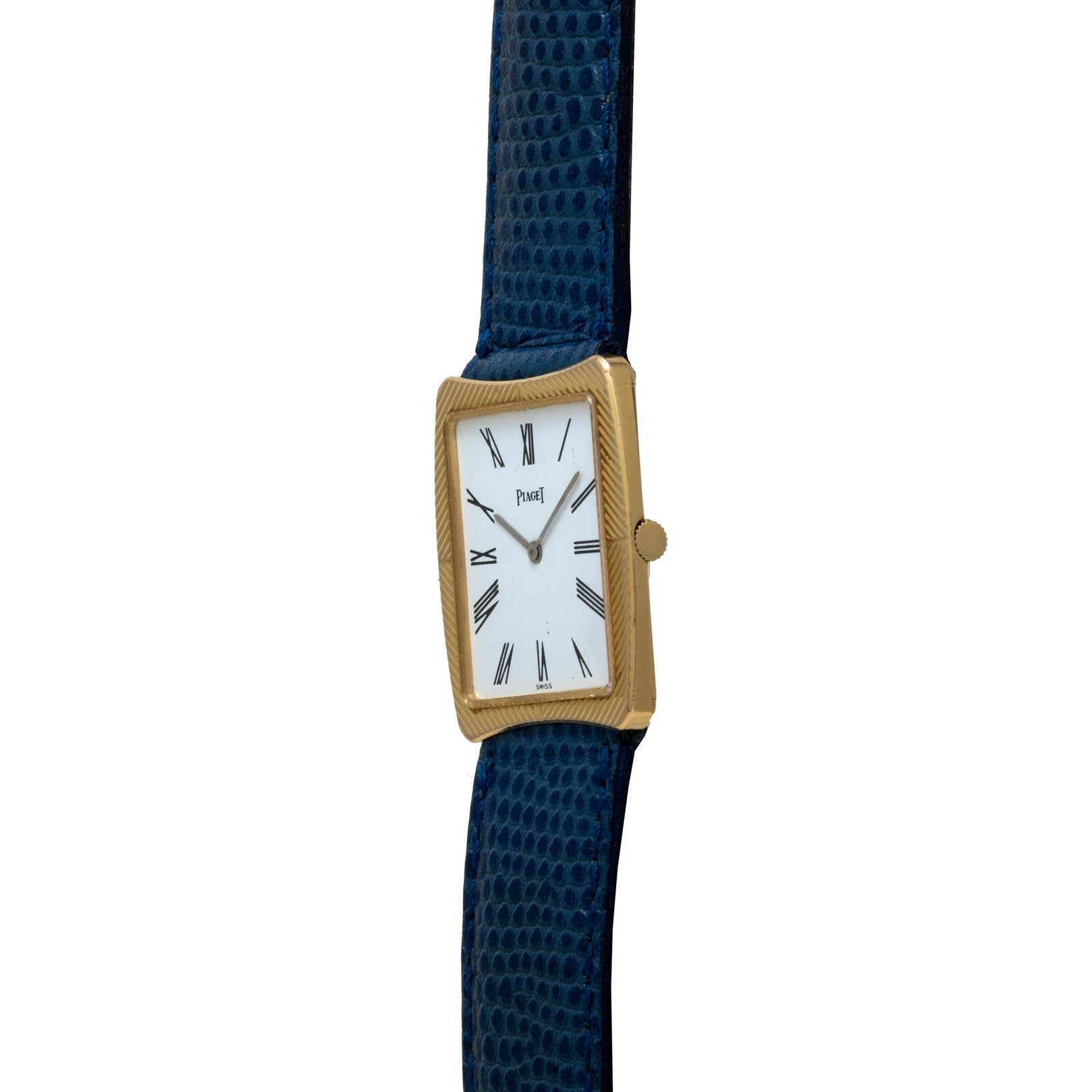 The Cartier Protocole is a gold rectangular watch featuring a white face, Roman numerals, and a dark blue textured leather strap.