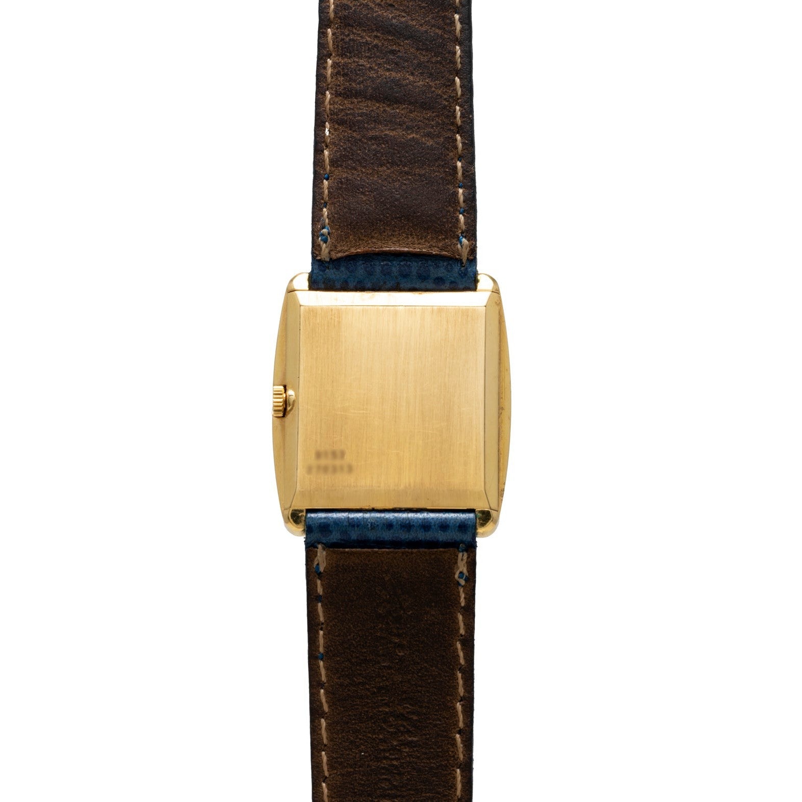 The Cartier Protocole gold rectangular watch features a brown leather strap, shown from the back with a plain case and visible stitching.