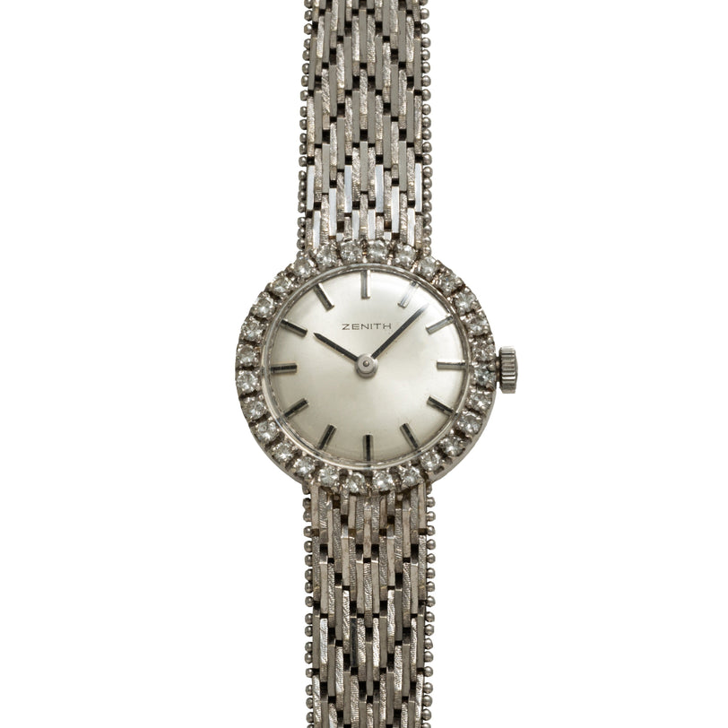 The Zenith Ladies Cocktail Watch features a diamond-studded bezel and a textured metal band, displayed against a white background.
