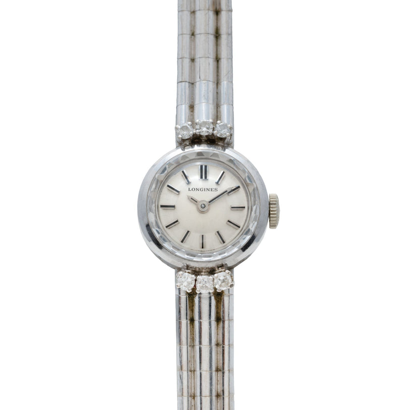 The Longines Diamond Cocktail Watch is a womens wristwatch with a silver metal link band and round white face, displayed on a white background.