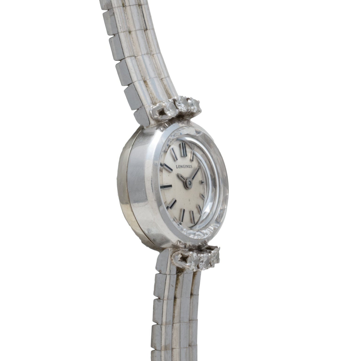 The Longines Diamond Cocktail Watch features a silver tone, round face, rectangular links, and diamond-accented bezel.