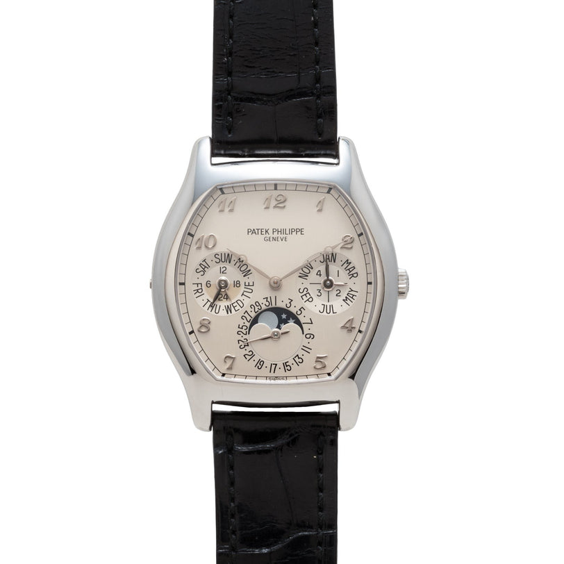 Patek Philippe Tonneau Perpetual Calendar wristwatch featuring a silver case, black leather strap, multiple dials, and date indicators.