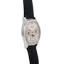 A Patek Philippe Tonneau Perpetual Calendar watch in silver with a black leather strap and a detailed calendar dial.