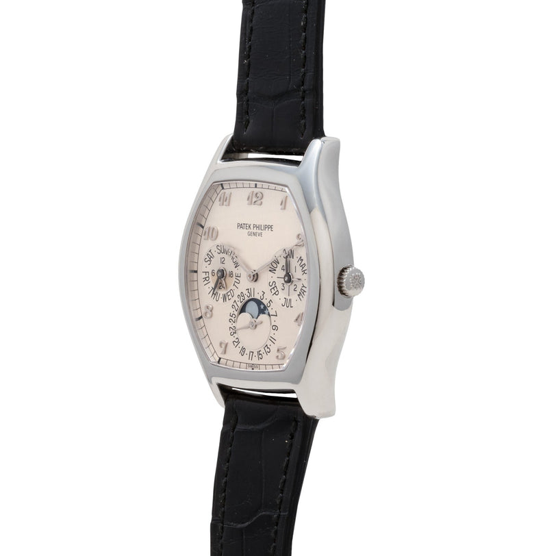 Patek Philippe Tonneau Perpetual Calendar wristwatch featuring a black leather band and multiple dials on a white face.