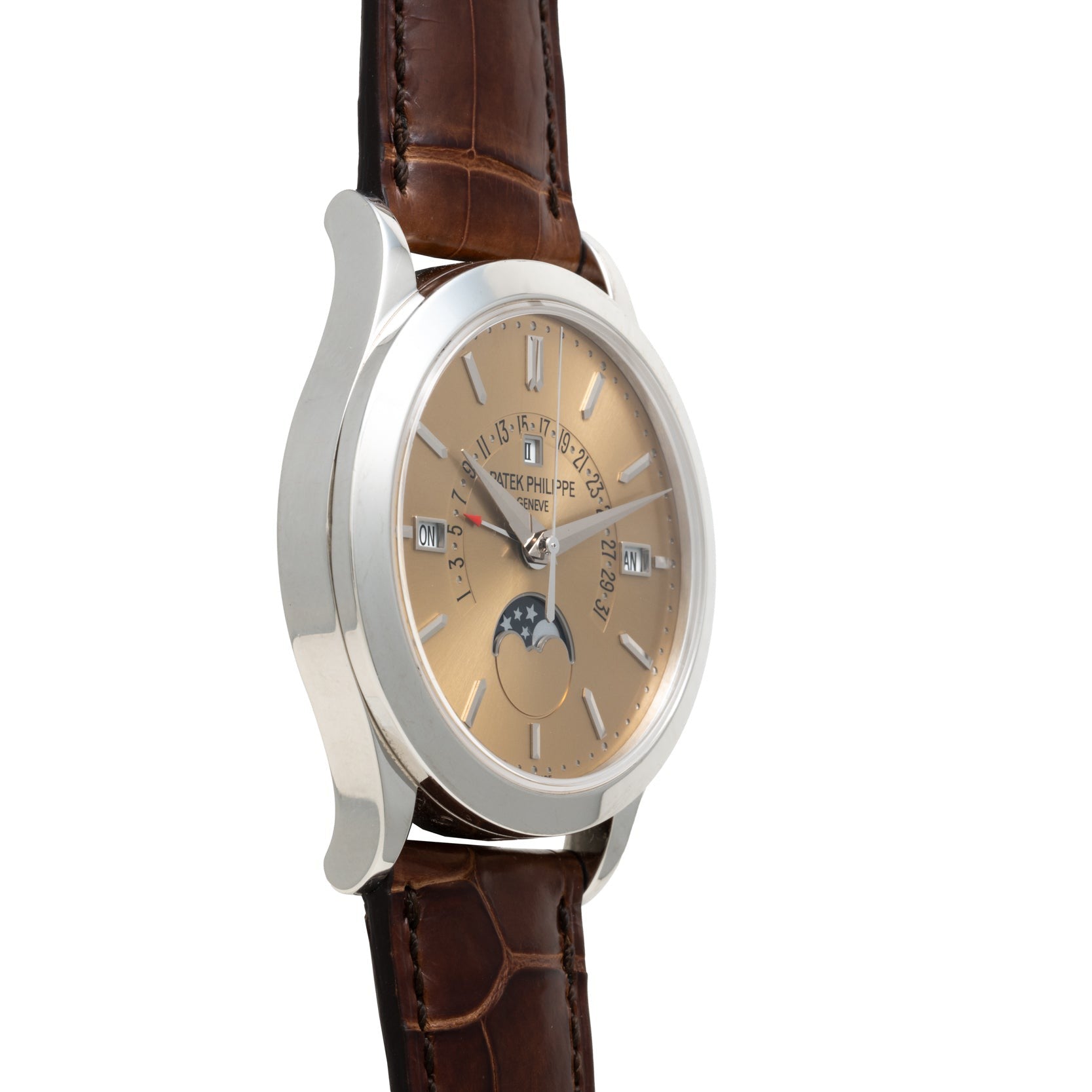 The Patek Philippe Retrograde Perpetual Calendar is a luxury wristwatch with a brown leather strap, silver case, beige dial, and moonphase display.