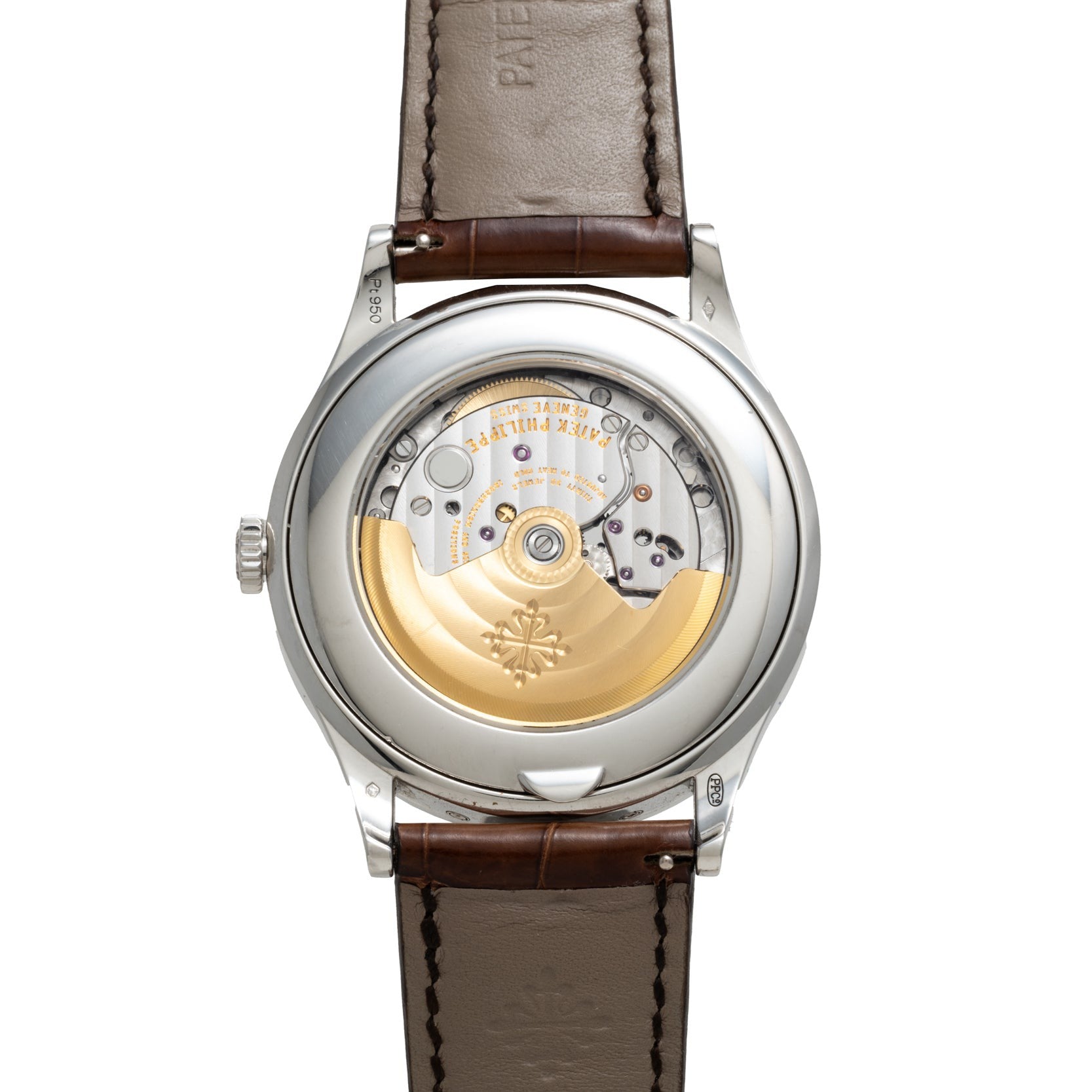 The back of a Patek Philippe Retrograde Perpetual Calendar reveals its mechanical movement and brown leather strap.