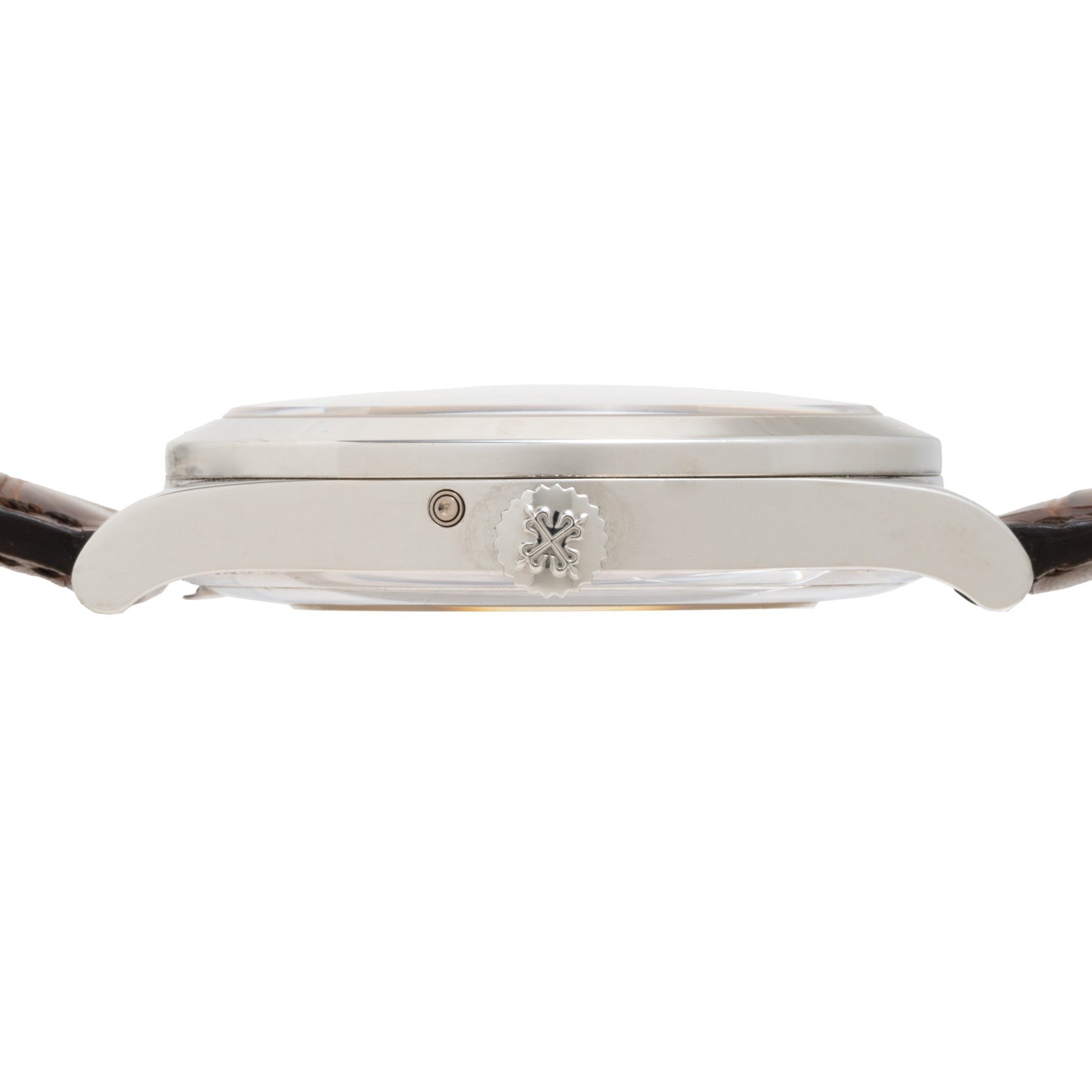 Side view of the Patek Philippe Retrograde Perpetual Calendar, featuring a silver case, brown leather strap, and an engraved crown.