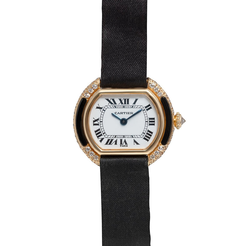 A Cartier Ellipse wristwatch featuring a black strap, gold case, Roman numerals, and diamond details on the sides.