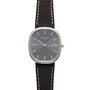 The Patek Philippe Ellipse features a gray dial, silver markers, and a black leather strap.