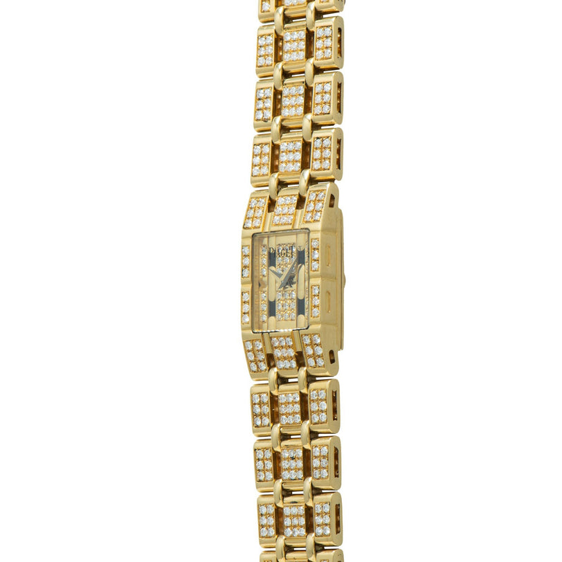 The Piaget Polo Pave is a gold wristwatch featuring a rectangular face and bracelet band, all encrusted with small diamonds.