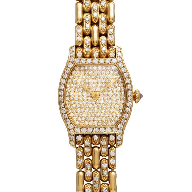 The Cartier Tortue Diamond wristwatch features diamond accents on the face, bezel, and band, and is showcased against a white background.