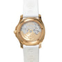 The Patek Philippe Aquanaut Ladies features a gold case back with visible mechanical movement and a white strap embossed with logos.