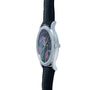 Side view of the Patek Philippe Calatrava Cloisonné Iris & Night Fireflies, a luxury watch featuring a black strap and a floral motif on the face.