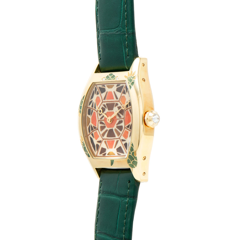 The Cartier Tortue XL Turtle Limited Edition features a gold case, green leather strap, and geometric patterned face, displayed from a side angle.