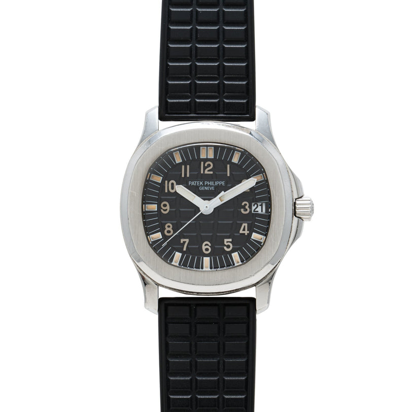 A Patek Philippe Aquanaut wristwatch featuring a black dial, black rubber strap, and date display.