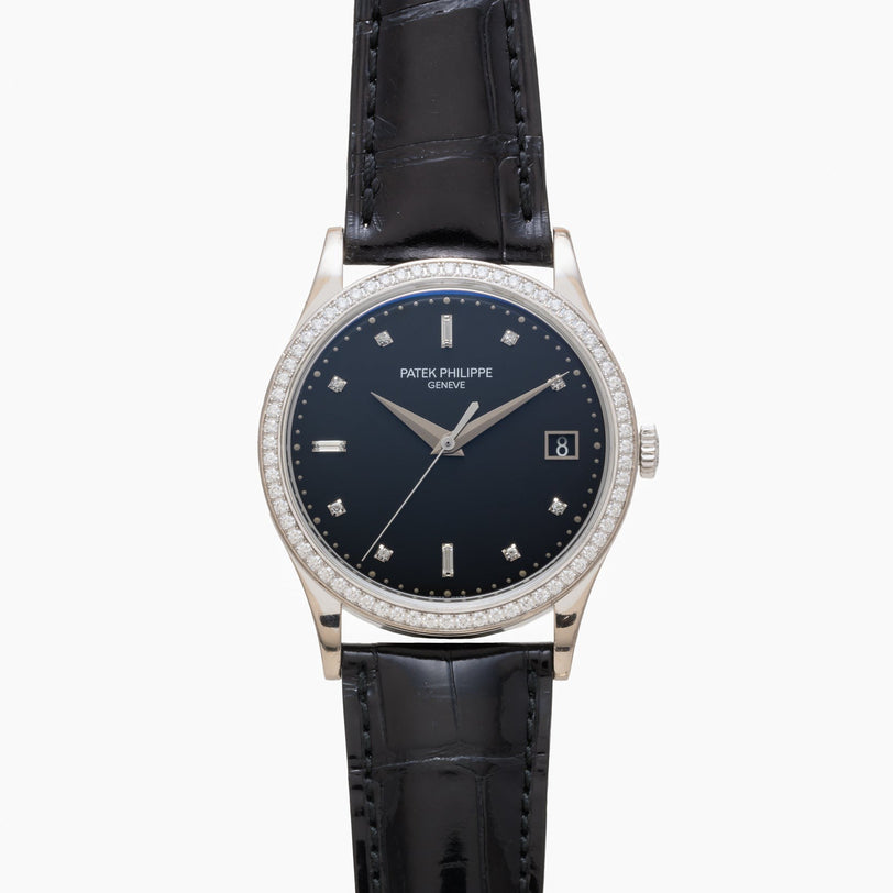 A Patek Philippe Calatrava Diamond Bezel watch featuring a black face, diamond bezel, and black leather strap.