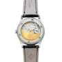 Back view of the Patek Philippe Calatrava Diamond Bezel, showcasing its exposed mechanical movement, gold rotor, and leather strap.